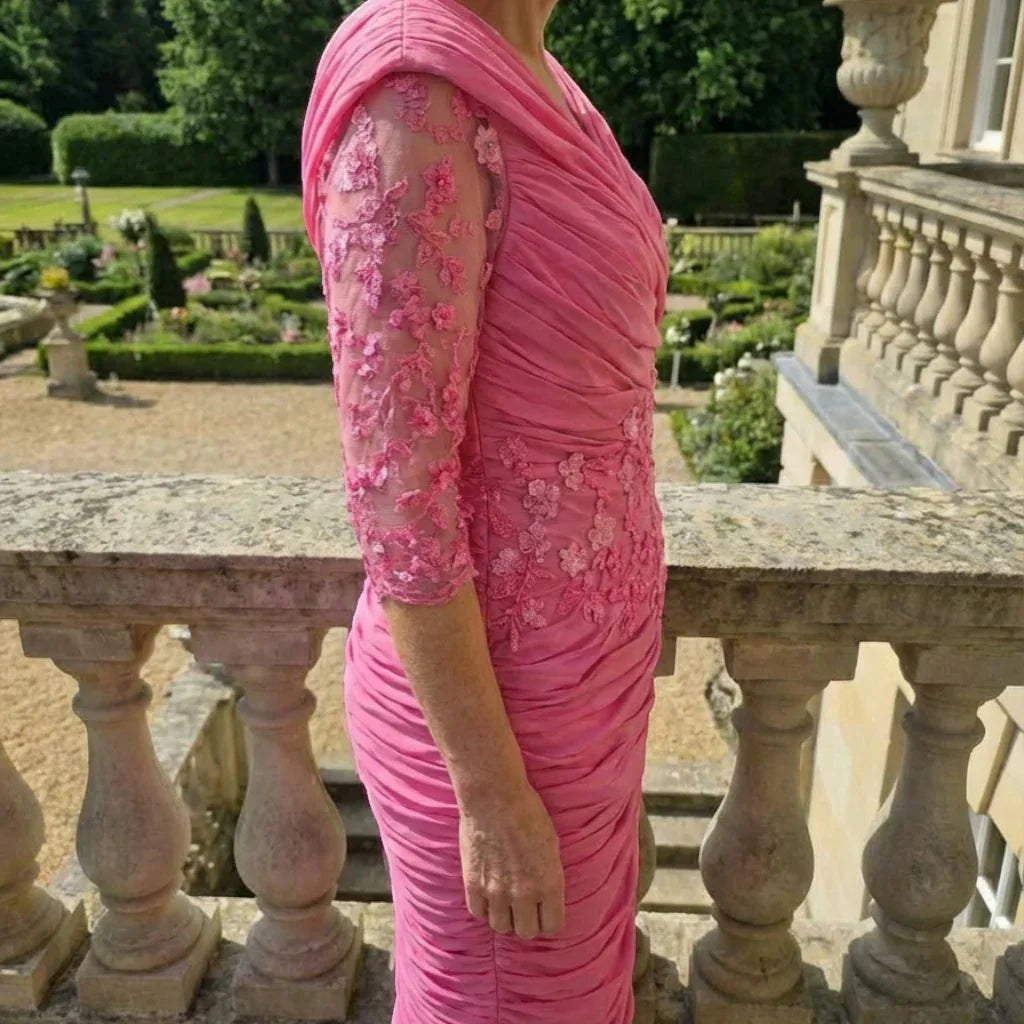 Side view of the Ispirato ISJ823 pink mother of the bride dress with ruched detailing and embellished sleeves.