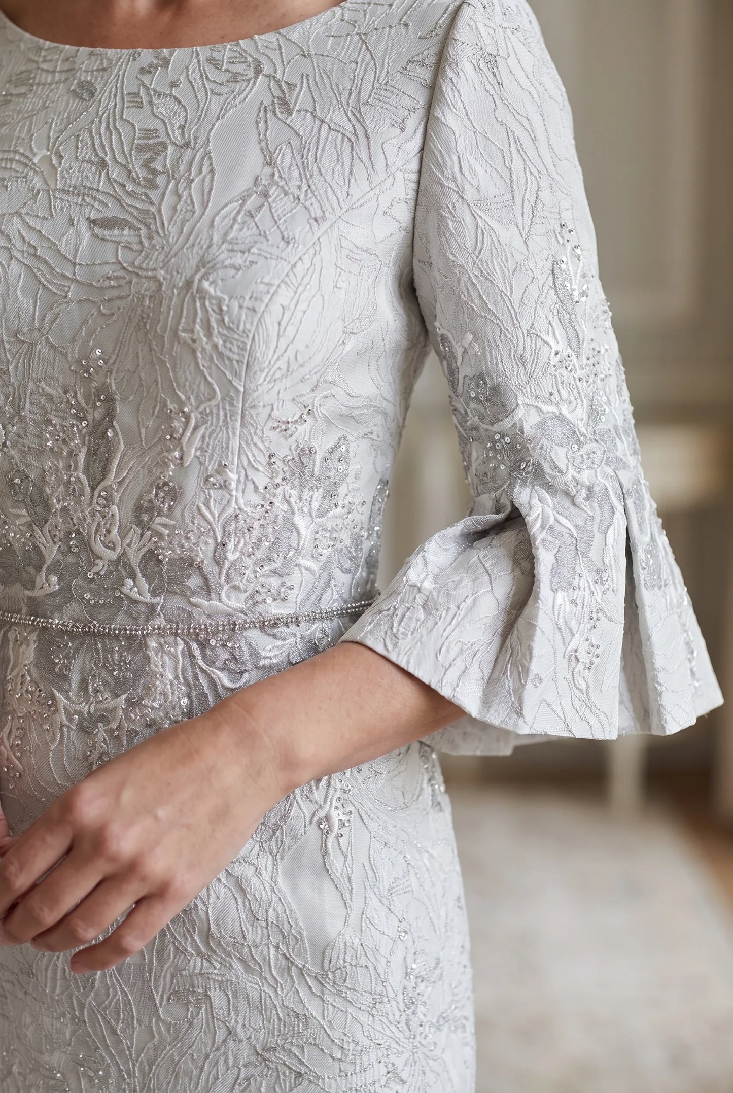 Close-up of the embroidered split sleeve detail on the John Charles 26713 Mother of the Bride dress