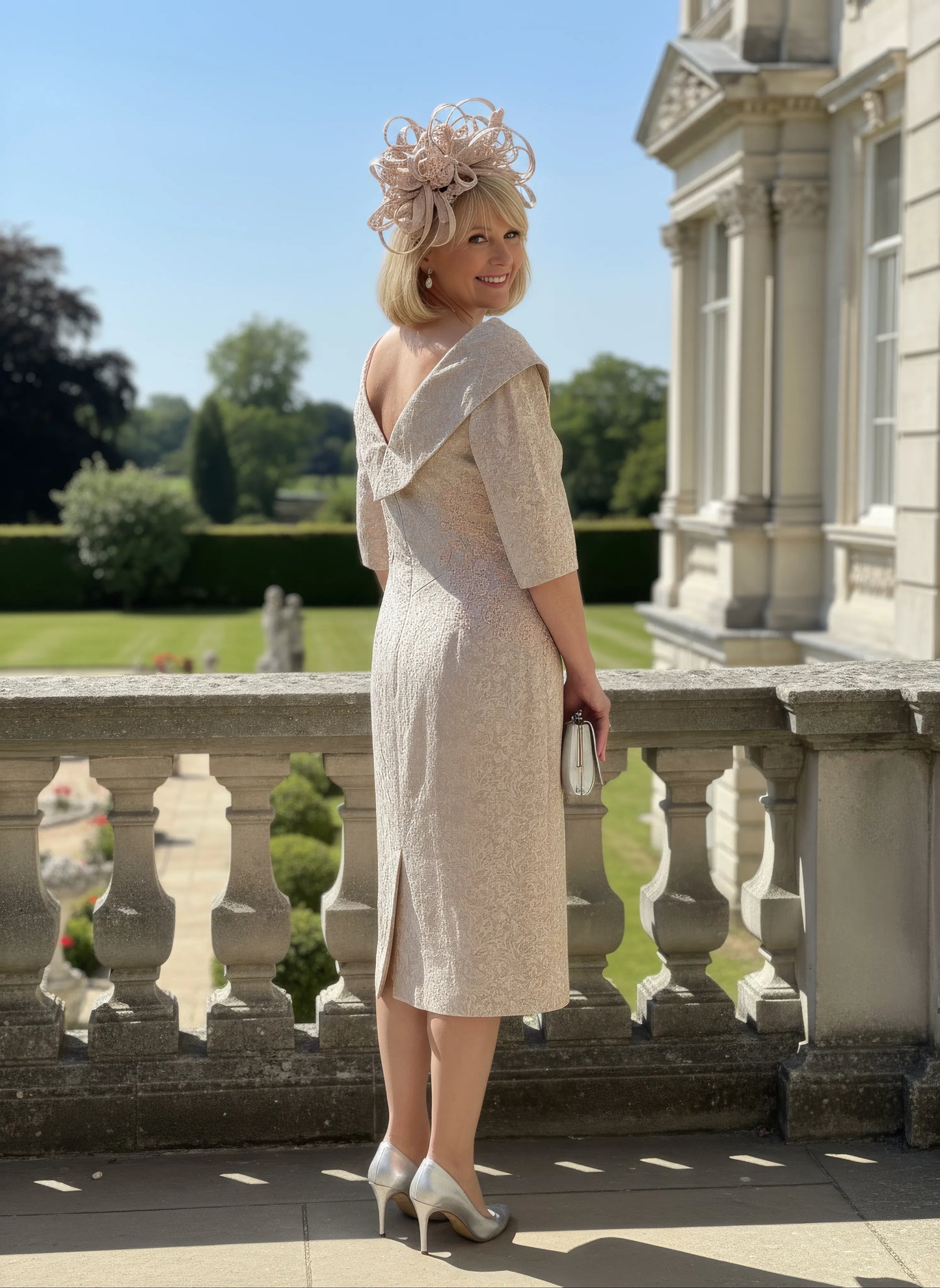 Woman wearing a beige john charles embroidered dress as mother of the bride - signature dress.