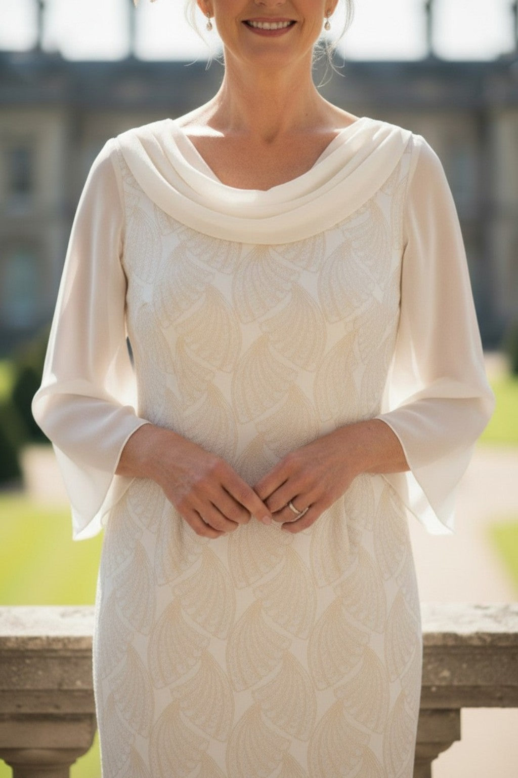 Woman wearing a champagne lightweight mother of the bride dress with a blurred background