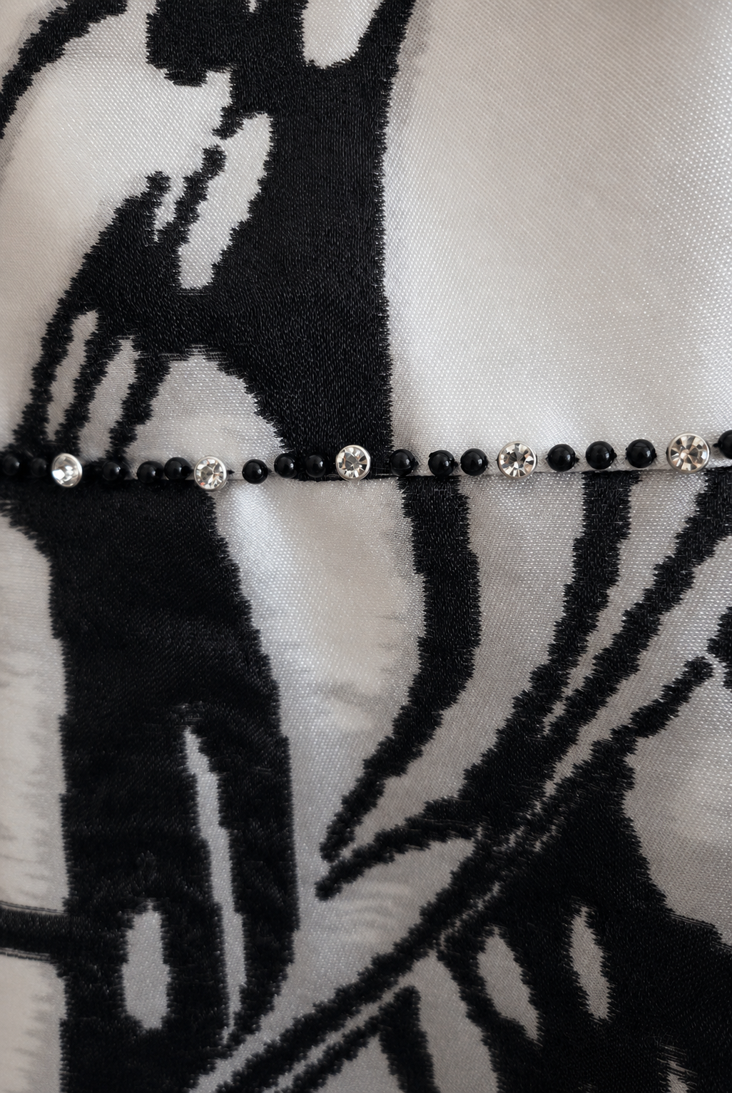 Close-up of the black floral corsage detail on the Lizabella 2266 mother of the bride dress.