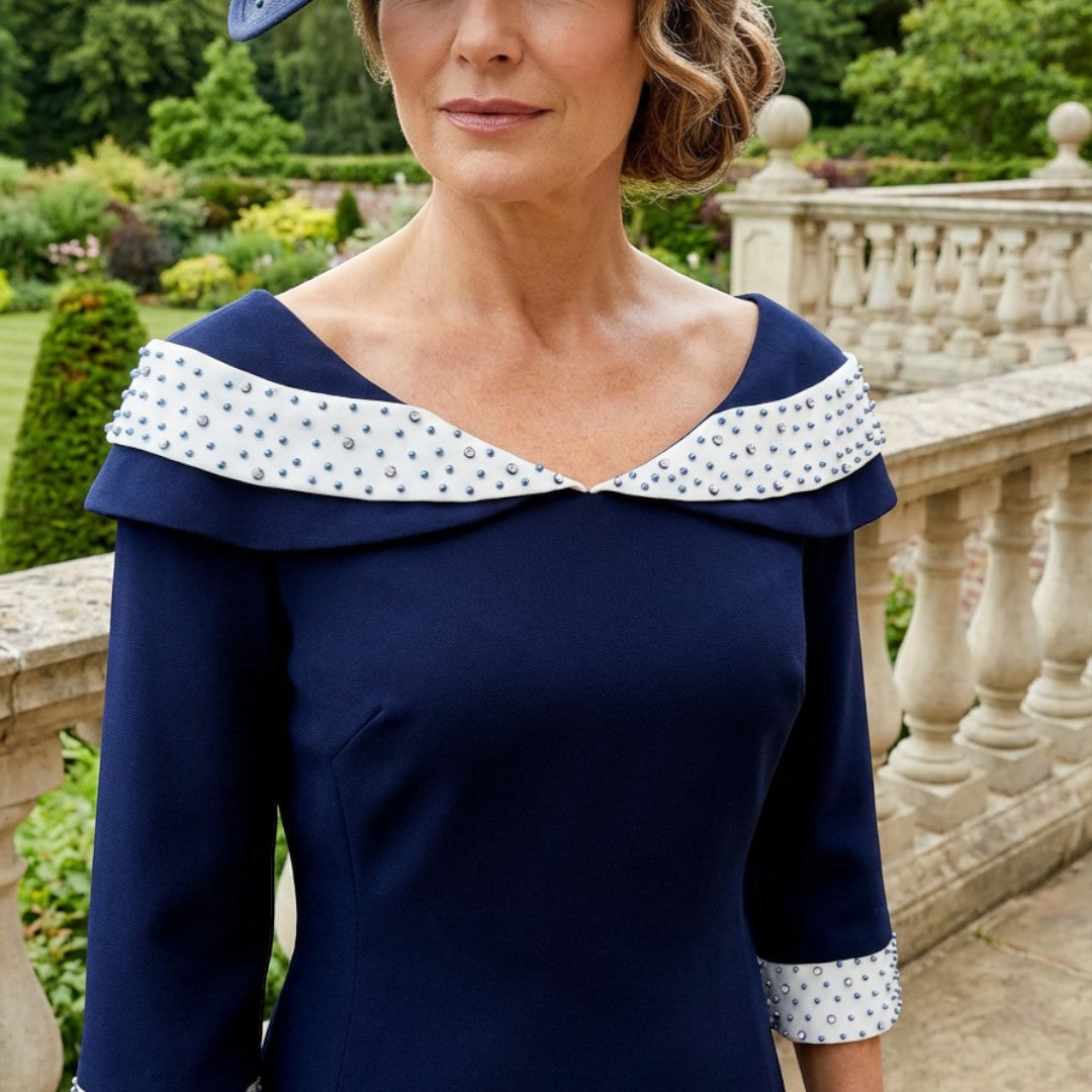 Lizabella 2461 navy Mother of the Bride dress with high-low skirt, pearl embellishments and elegant A-line silhouette, close view.