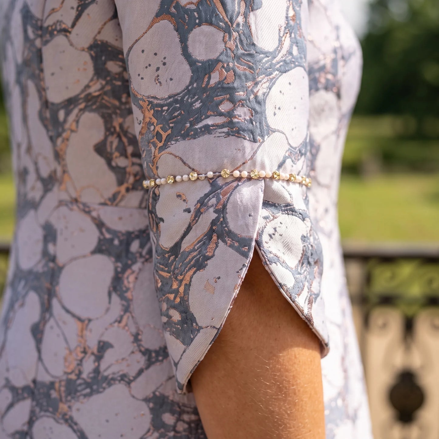 Close up of the pearl and crystal trim on the Lilac Mother of the Bride Dress by Lizabella 2493