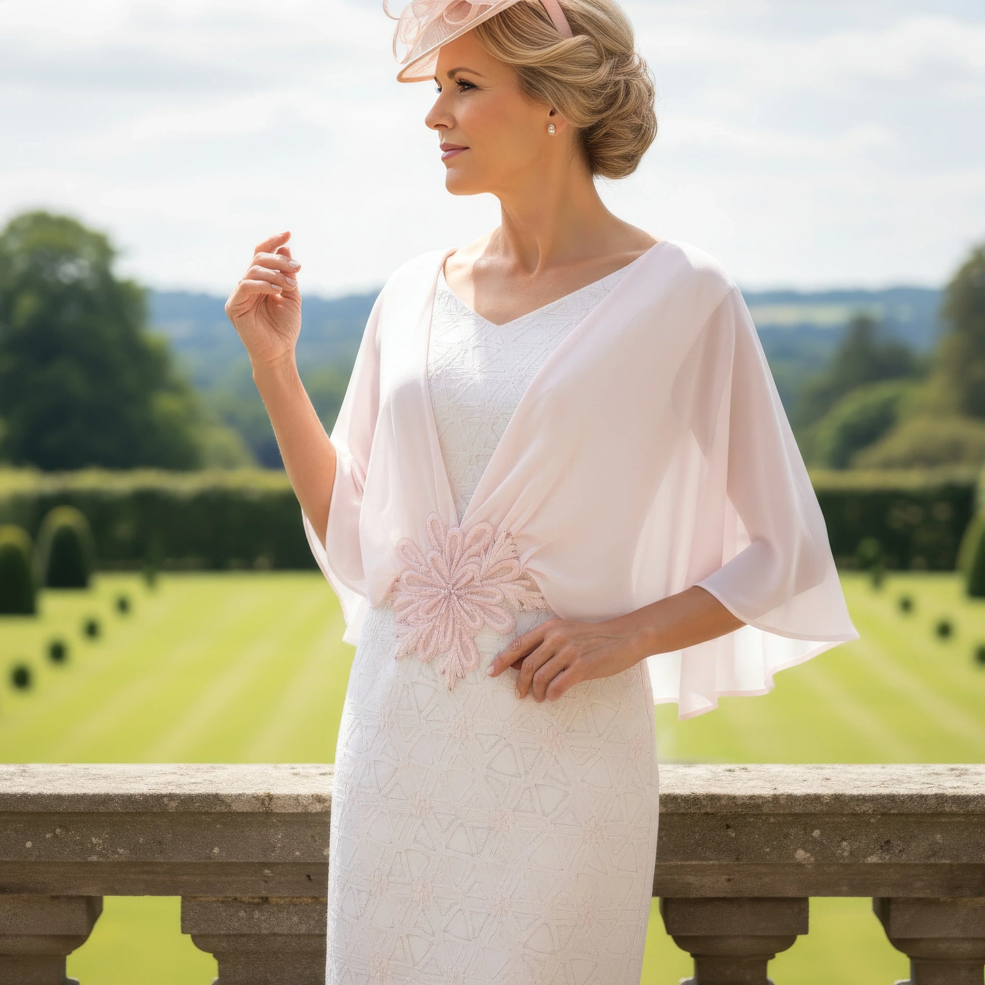 close view of Lizabella 2499 blush pink Mother of the Bride dress with chiffon cape sleeves and embellished waist.