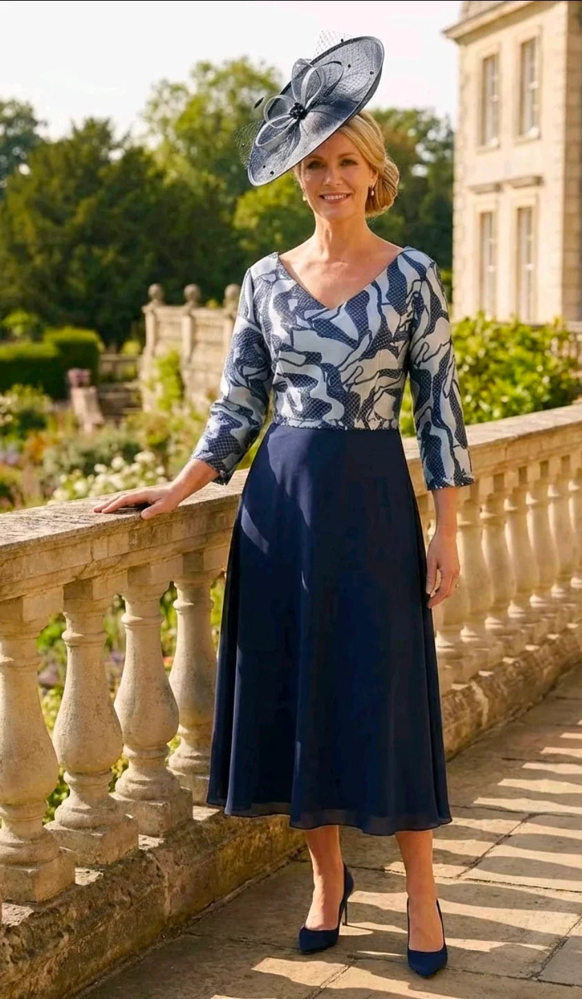 Front view of the Lizabella 2513 navy mother of the bride dress with metallic bodice and chiffon skirt.