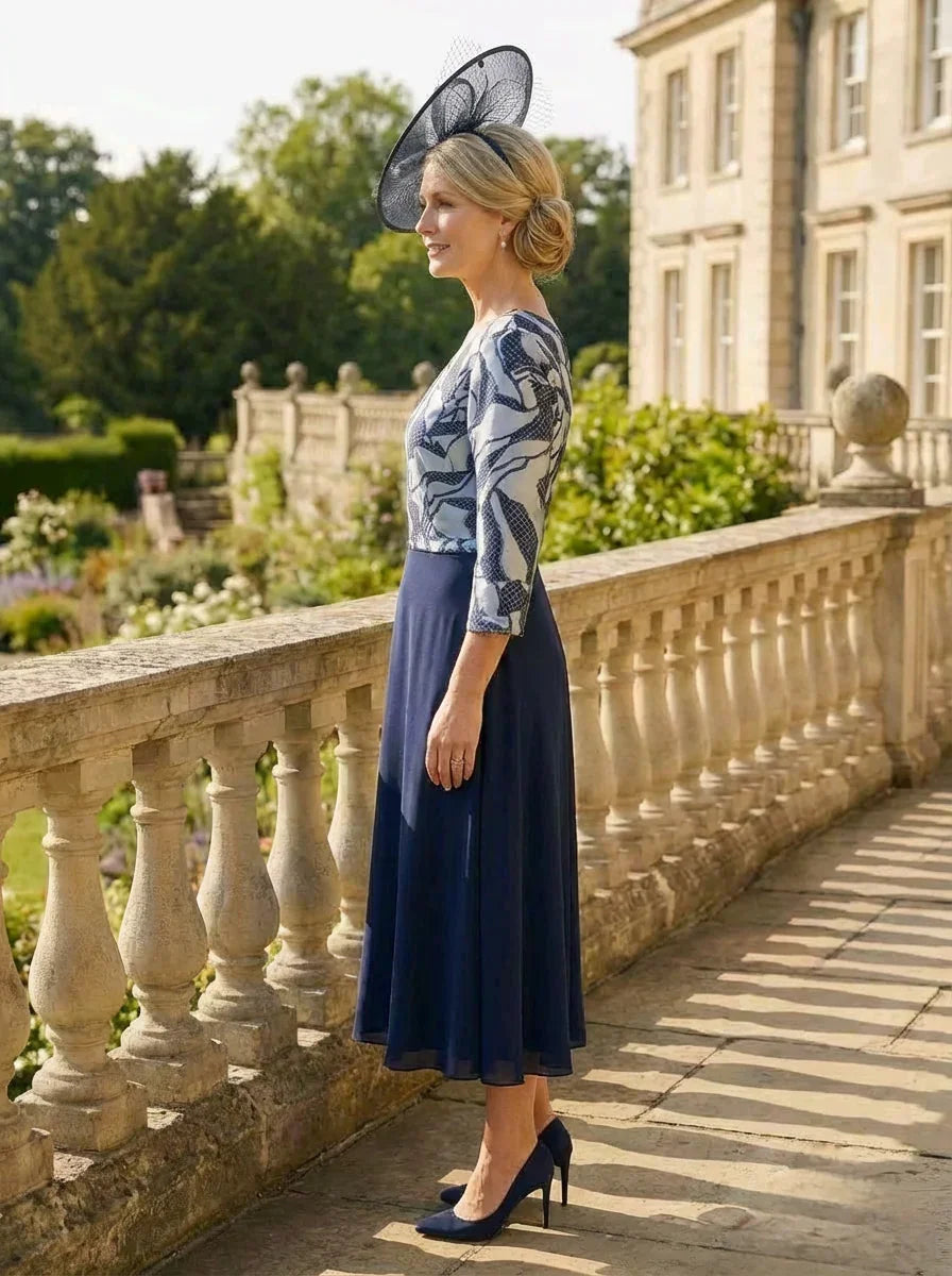 Side view of the Lizabella 2513 navy mother of the bride dress showing the metallic pattern and chiffon movement.