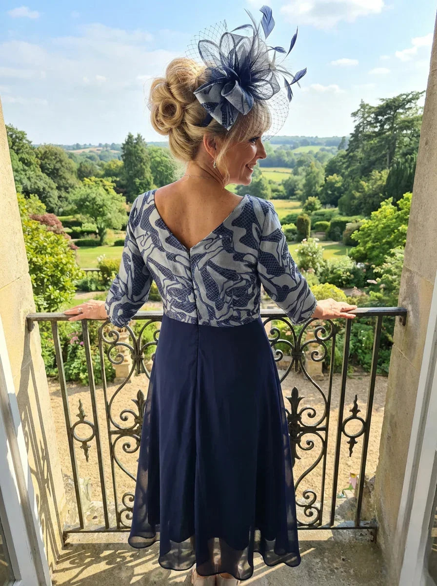 Back view of the Lizabella 2513 navy mother of the bride dress with V-back and flowing chiffon skirt.