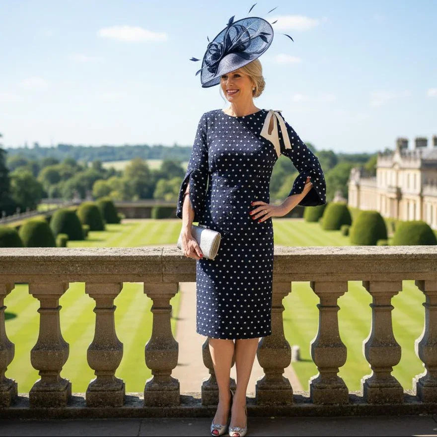 Lizabella 2548 navy Mother of the Bride dress with polka dot fabric, bow shoulder detail and boat neckline.
