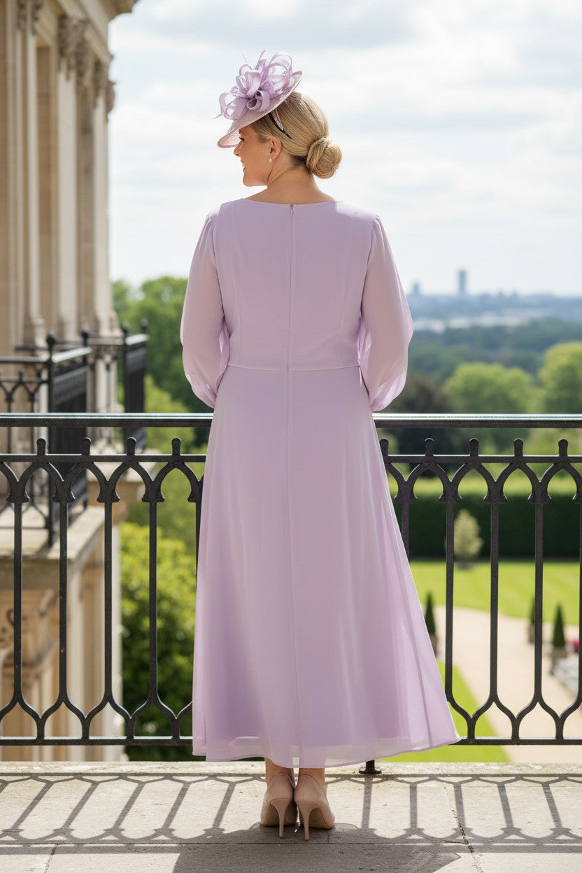 Lizabella 2662 lilac Mother of the Bride dress with flowing chiffon, long sheer sleeves and pearl embellished waist, with her back. 