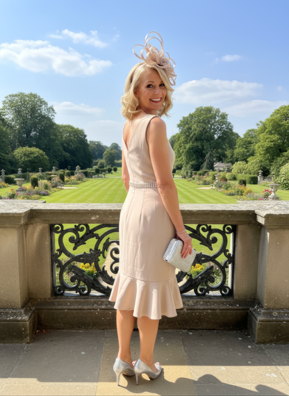 women wearing a Mother of the Bride outfit by designer Mascara, the dress is v neck with a matching jacket.