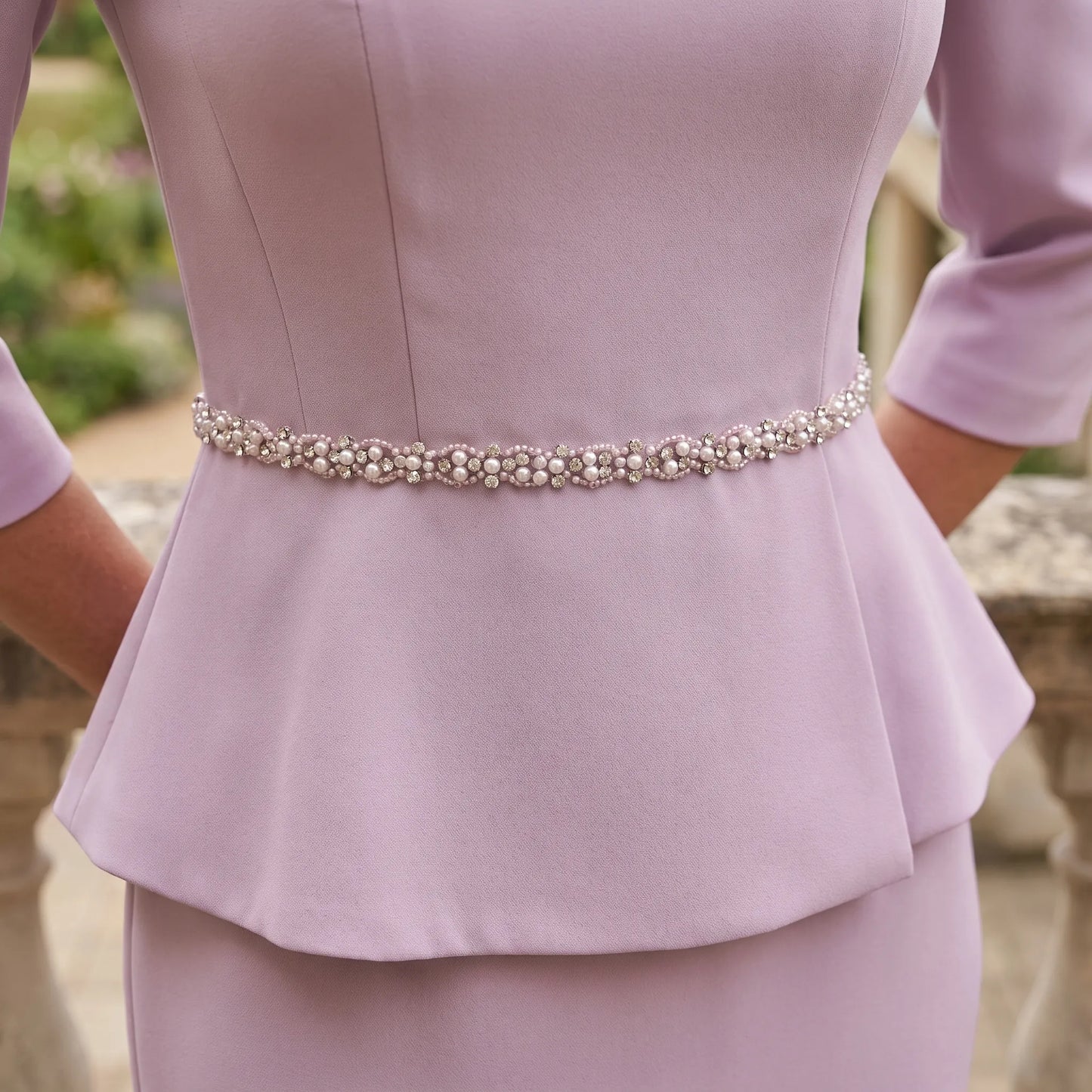Close-up of the John Charles 26701A Mauve Mother of the Bride dress showing the crystal embellished waist and luxurious stretch crepe fabric.