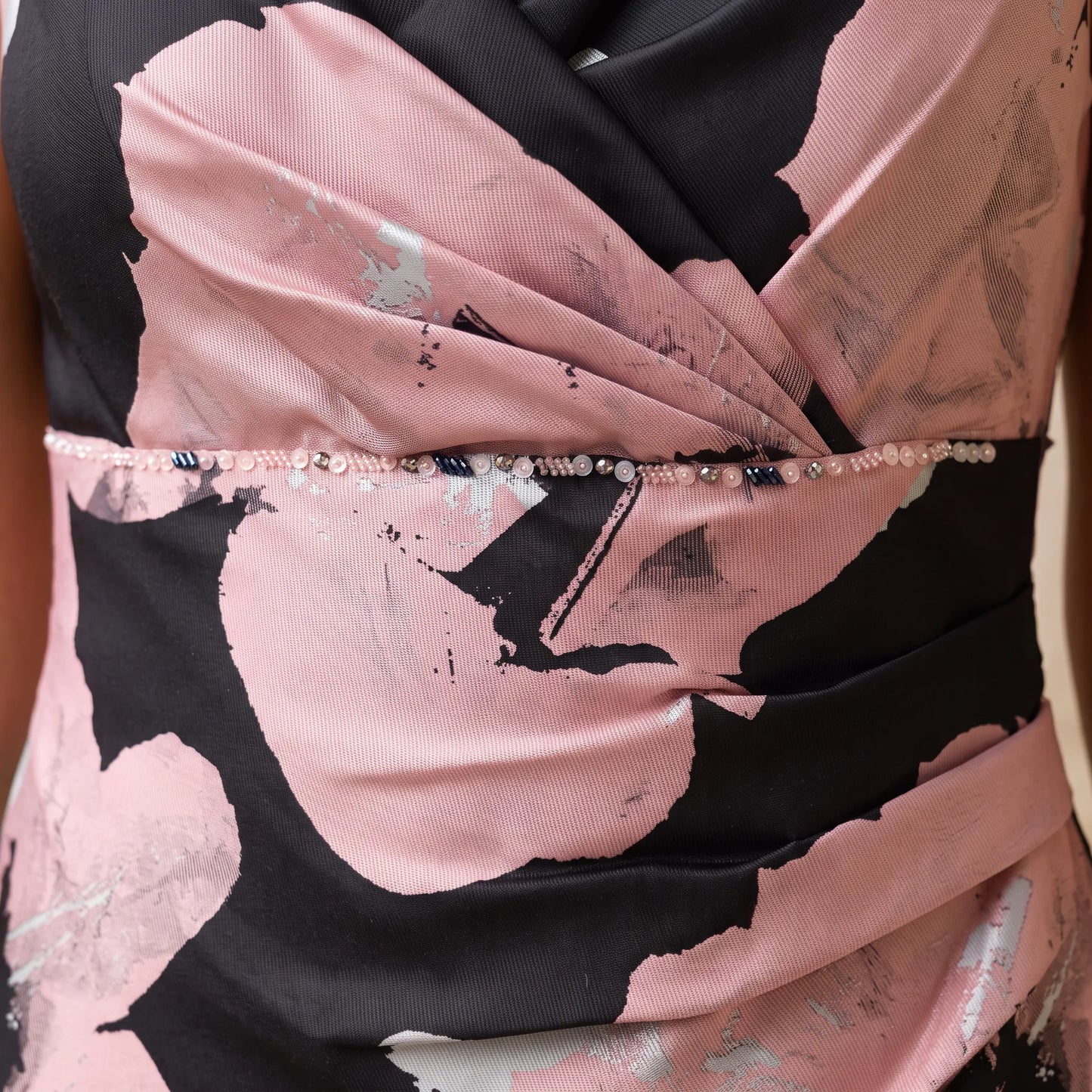 Close-up of the wrap waist detail with metallic floral print on the Pink Mother of the Bride Dress by Ispirato.