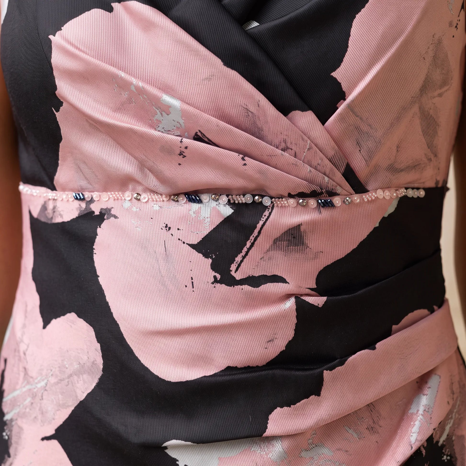 Close-up of the wrap waist detail with metallic floral print on the Pink Mother of the Bride Dress by Ispirato.