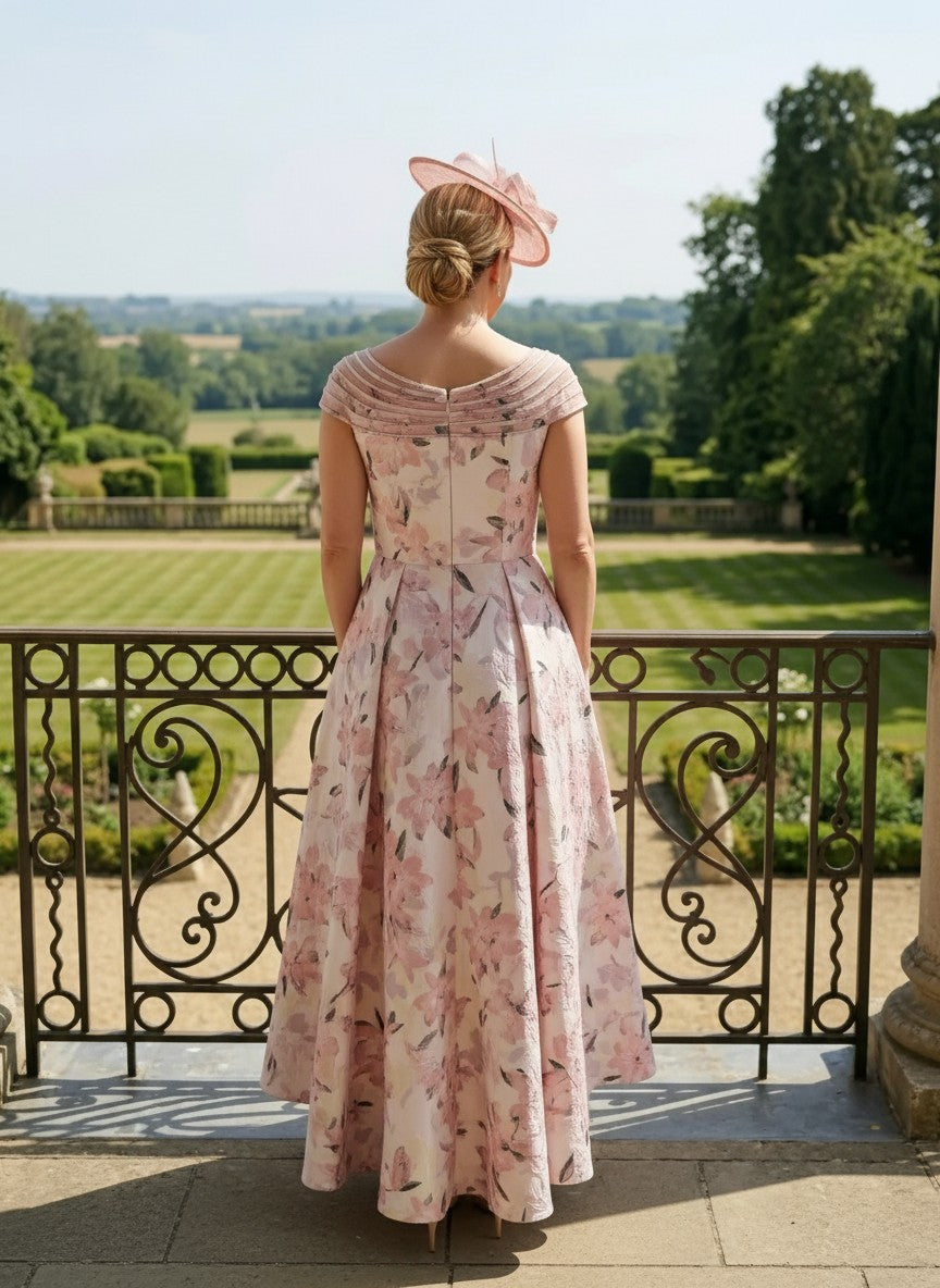 Back view of Couture Club 8G1F9 pink Mother of the Bride dress with dipped hem and structured silhouette.