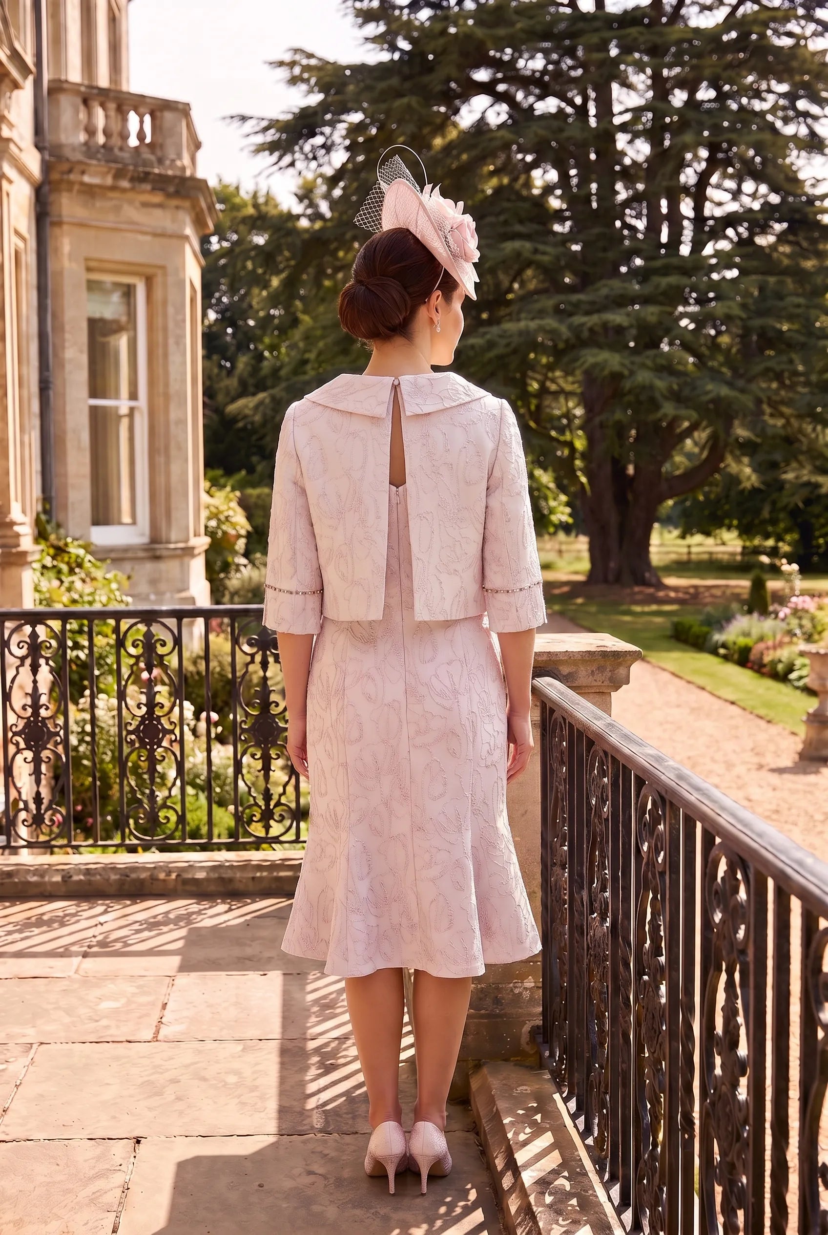 Rear view of the Pink Mother of the Bride Outfit by Lizabella 7153 showing the back-fastening cropped jacket and elegant fitted silhouette.