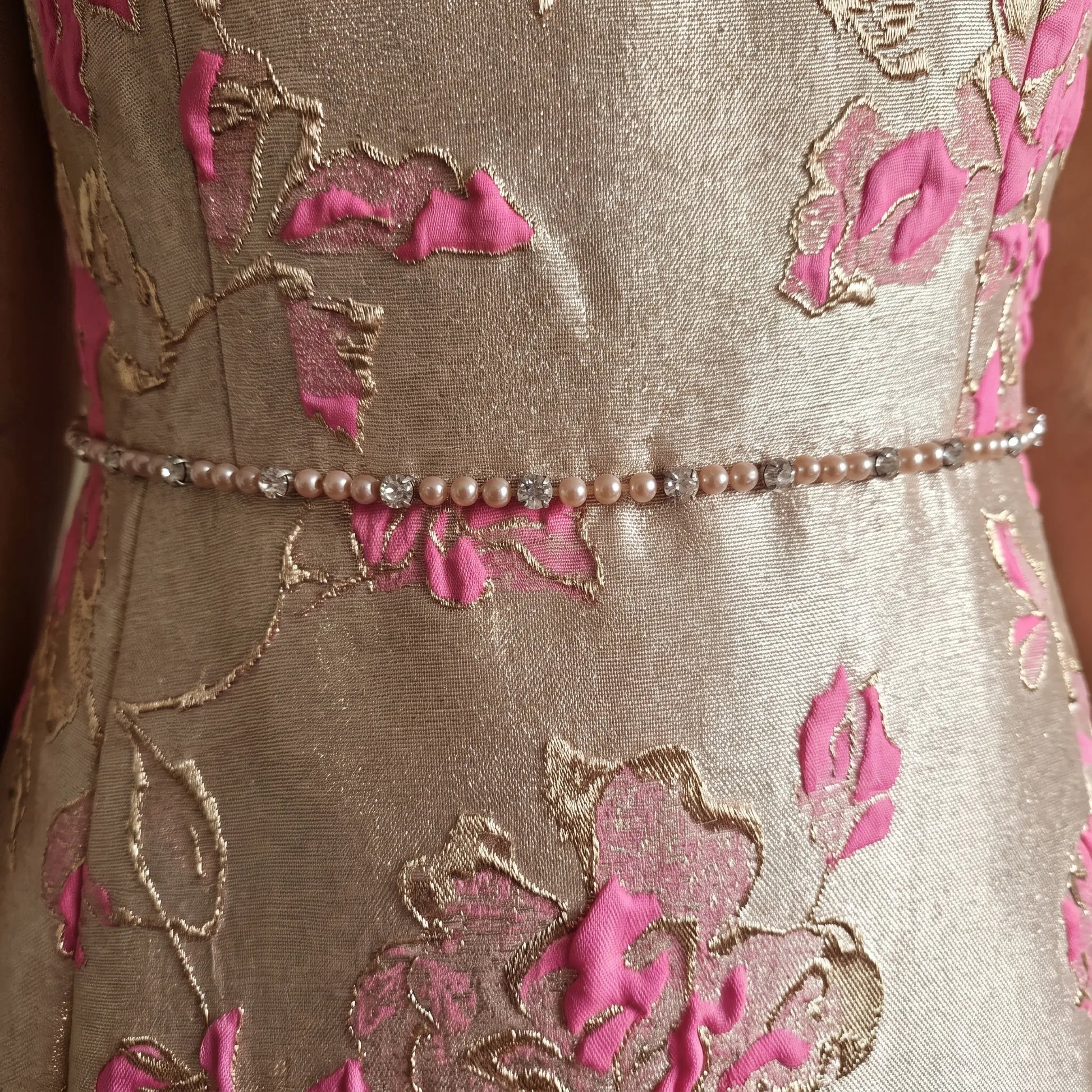Close-up of the Lizabella 7224 floral jacquard fabric featuring shimmering champagne and vibrant pink floral detailing.