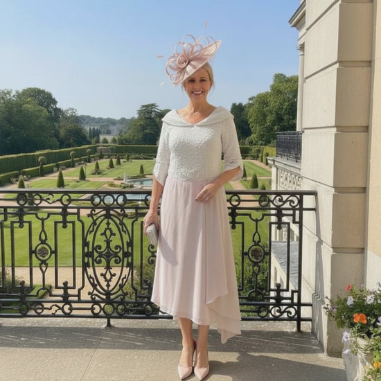 Woman in a blush pink Mother of the bride dress by Lizabella. Signature Dress