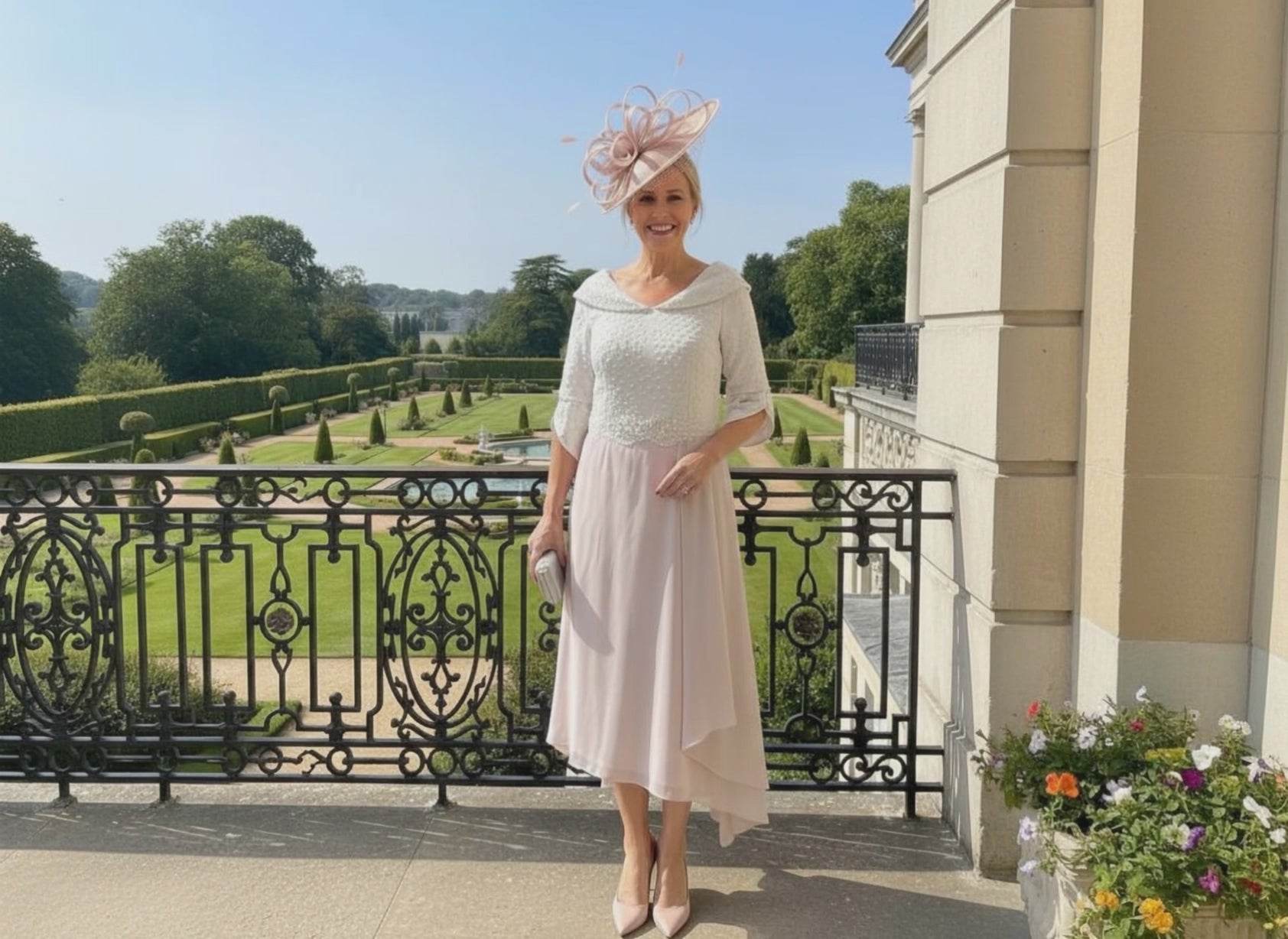 Woman in a blush pink Mother of the bride dress by Lizabella. Signature Dress