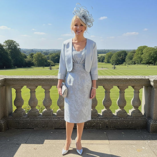 Woman in a light blue mother of the bride dress and jacket. Signature Dress