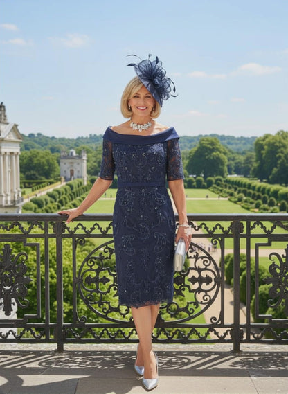 Woman in a navy Veni Infantino dress with lace details standing on a balcony with a scenic background