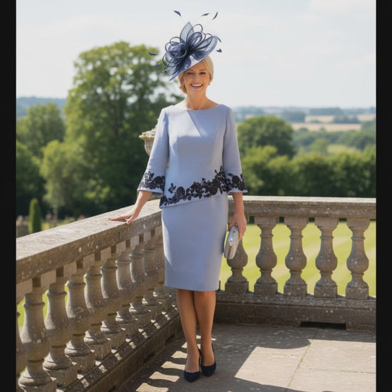 Woman in a light blue mother of the bride dress with navy floral lace by veni infantino - Signature Dress.