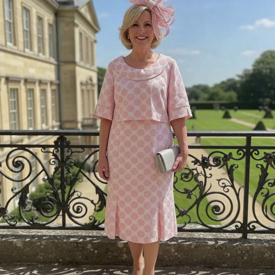 Woman in a Lizabella Mother of the bride 2 piece pink polka dot dress. Signature Dress
