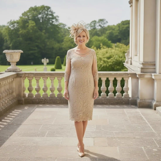 Woman in a condici beige mother of the dress and matching beige fascinator ready to attend a wedding. Signature Dress.