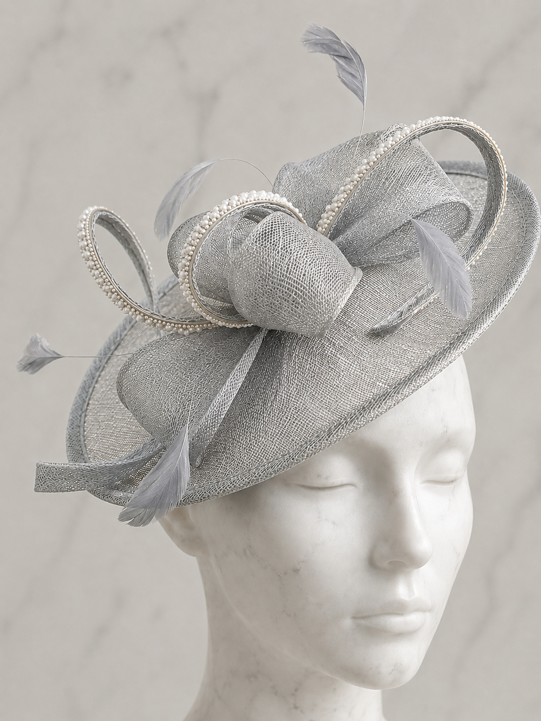 a embellished silver fascinator hat with feathers, sparkly rhinestones and pearls outdoors