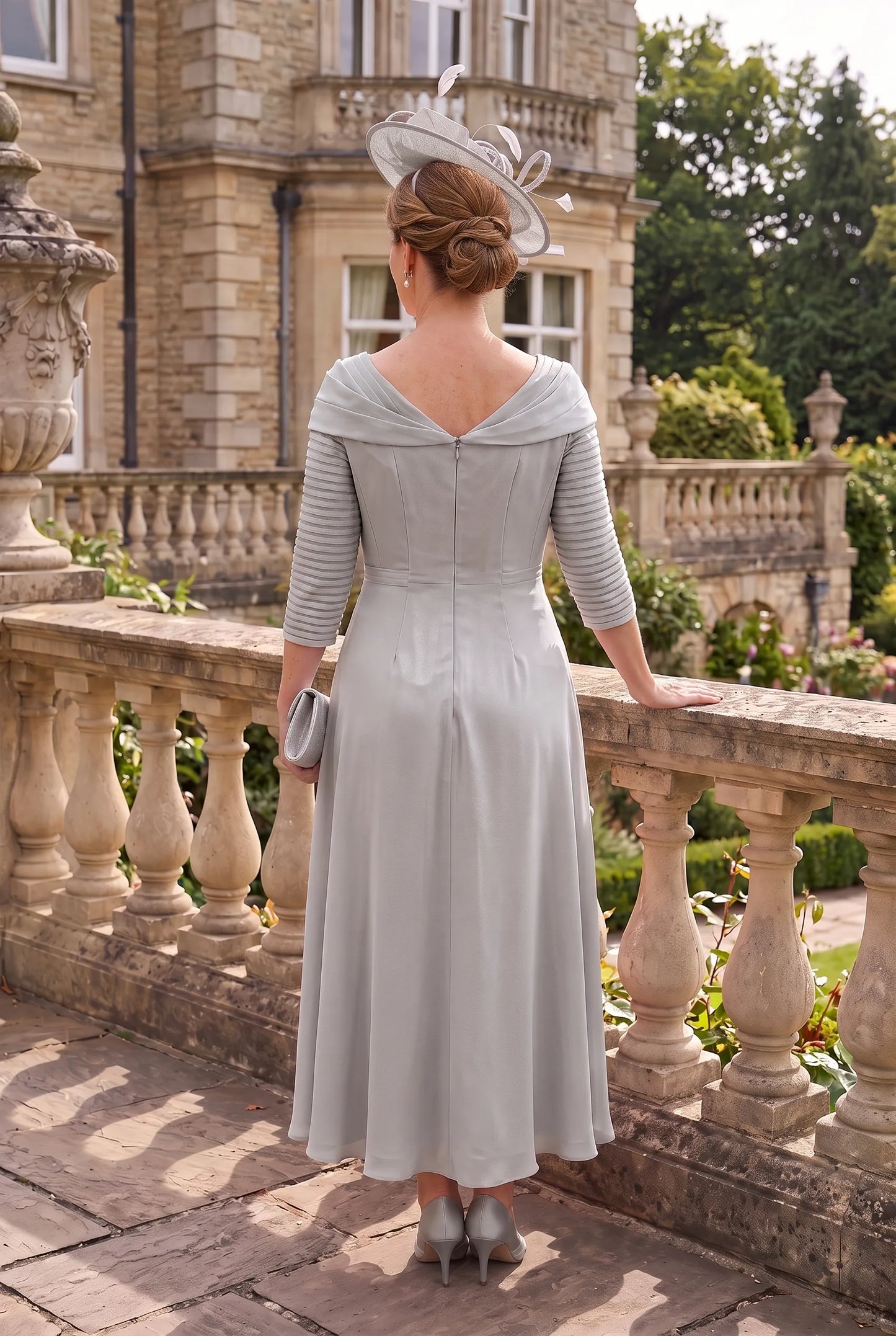 Rear view of the Silver Mother of the Bride Dress by Couture Club 5G114 showing the elegant chiffon skirt and flattering silhouette.
