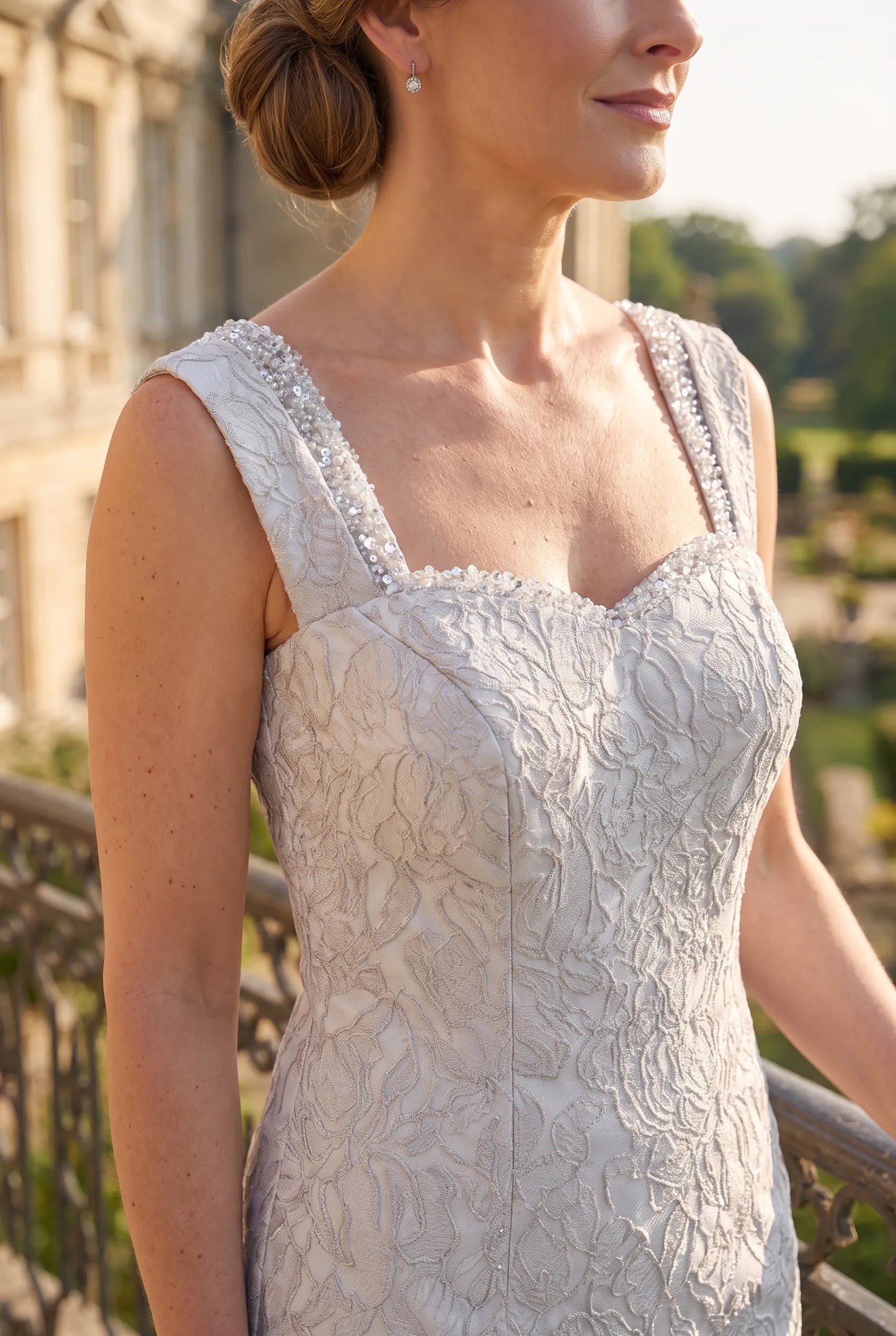 Close-up of the embossed floral bodice on the silver John Charles 26438B Mother of the Bride dress