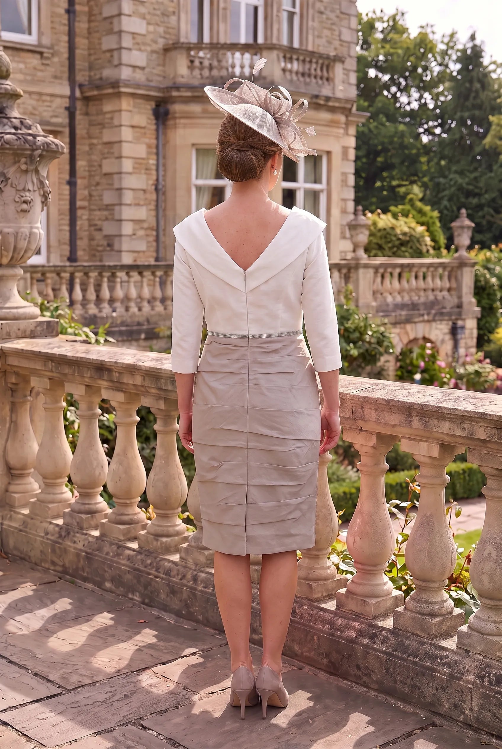 Rear view of the Taupe Mother of the Bride Dress by Ispirato ISK817 showing the elegant fitted silhouette and back detailing.