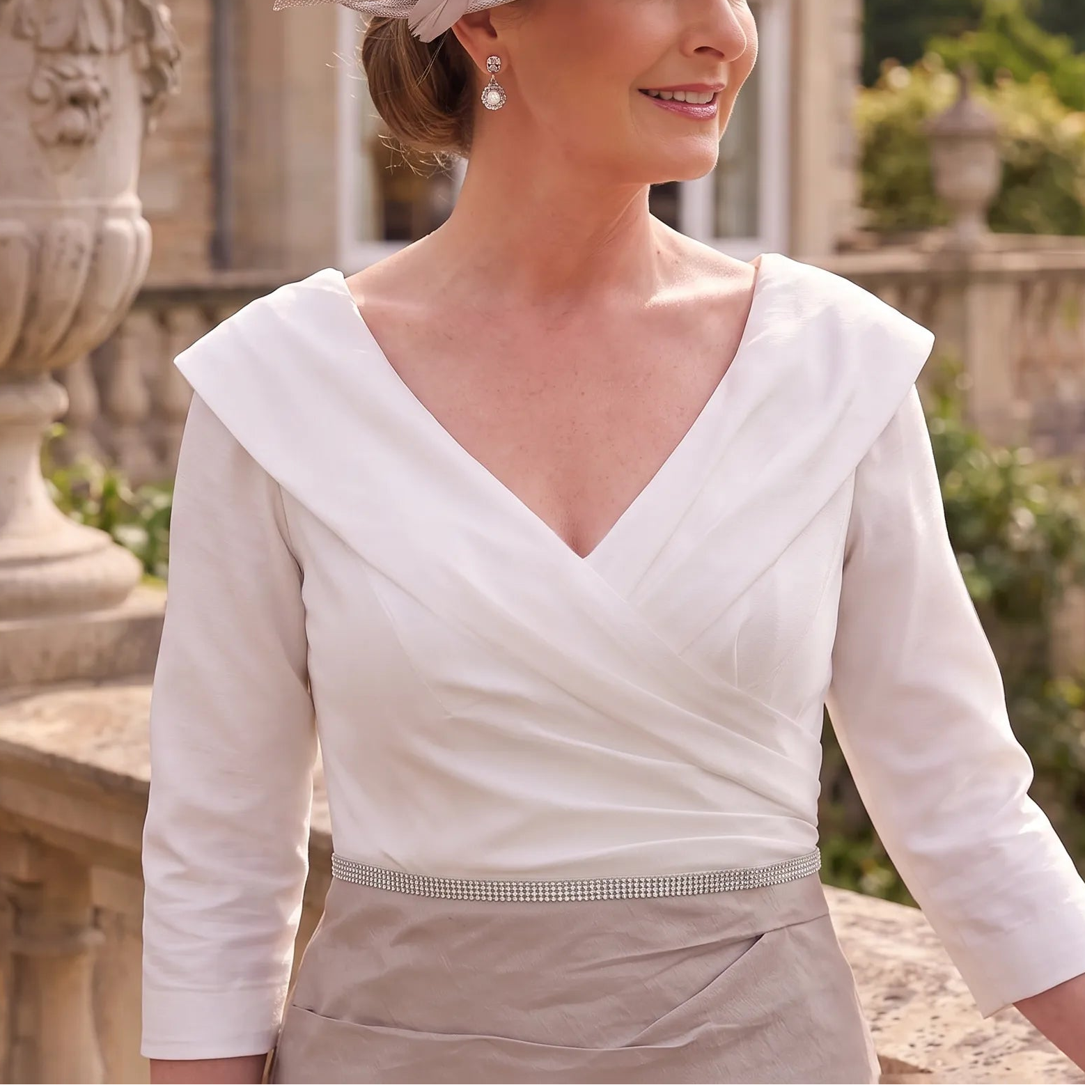 Close-up of the Ispirato ISK817 Taupe Mother of the Bride dress showing the crossover neckline, ruched bodice and defined waistband.