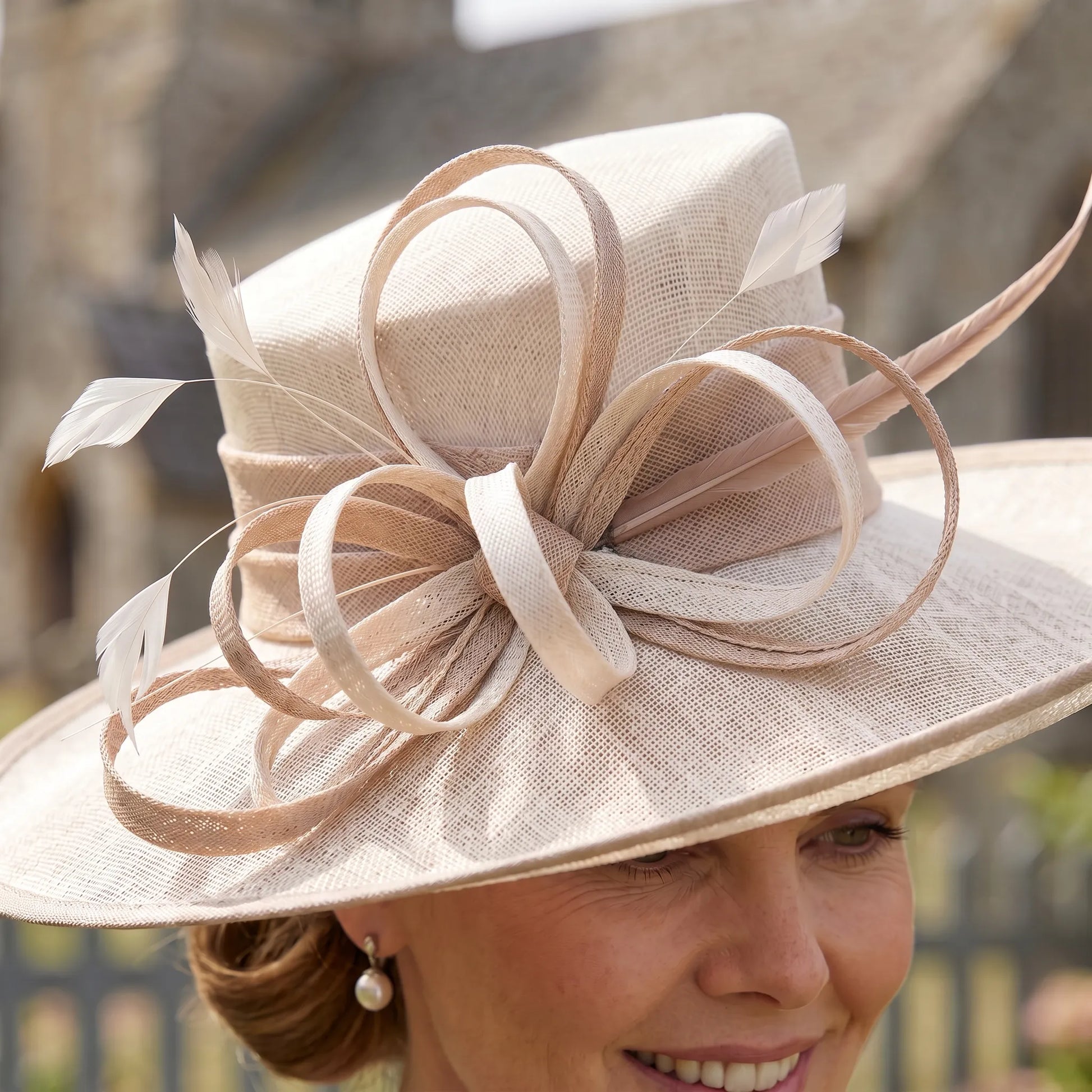 Side view of Condici 7384C taupe wedding hat with feather detail