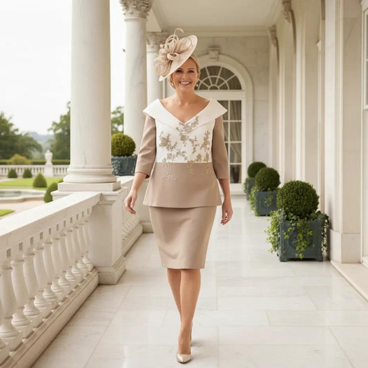 Woman in elegant curvy taupe mother of the bride outfit walking on a classical architectural porch