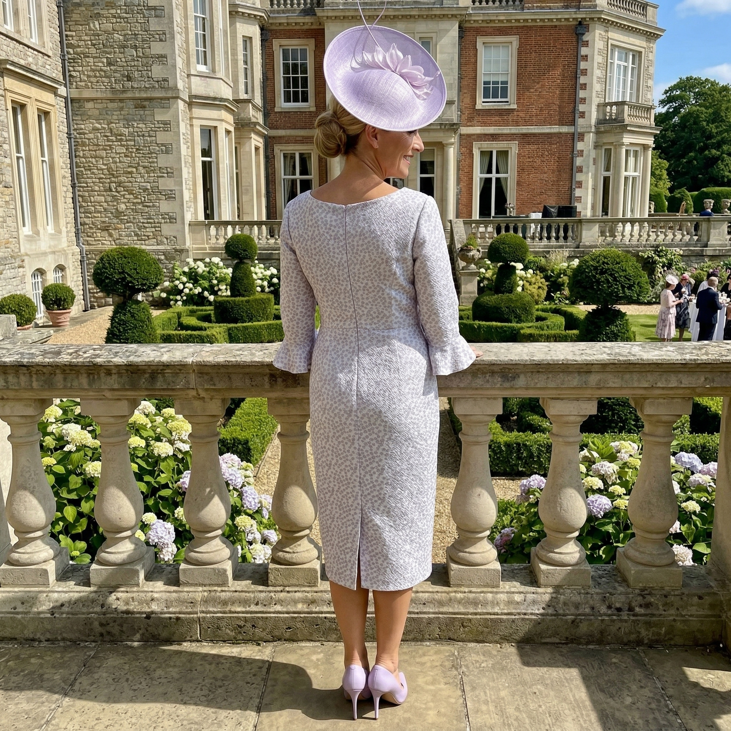 Back view of lilac Veromia DU458 dress with concealed zip and below‑knee length.
