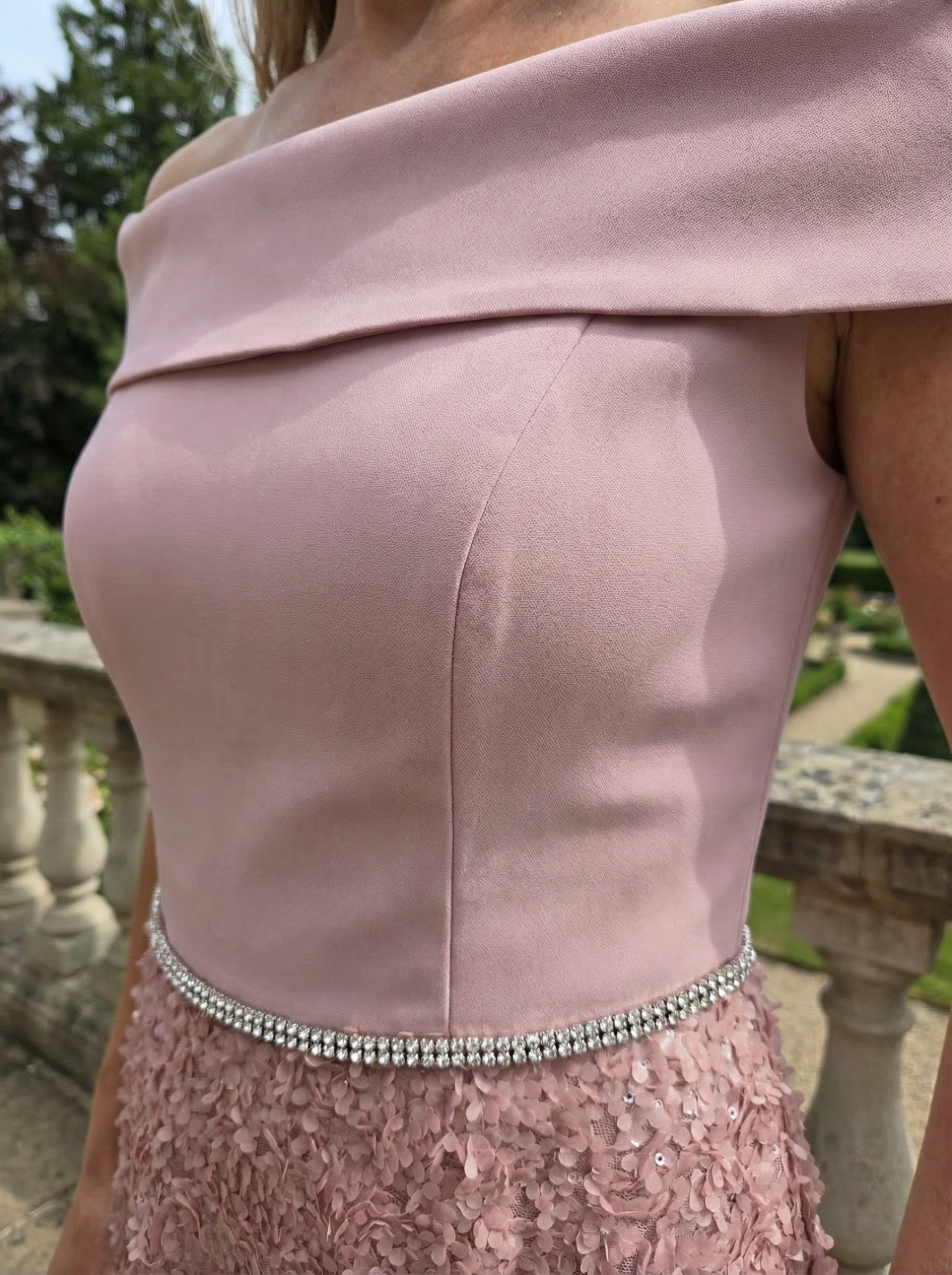 Close-up of soft pink Veromia VO6534 Bardot neckline with rhinestone waist detail.