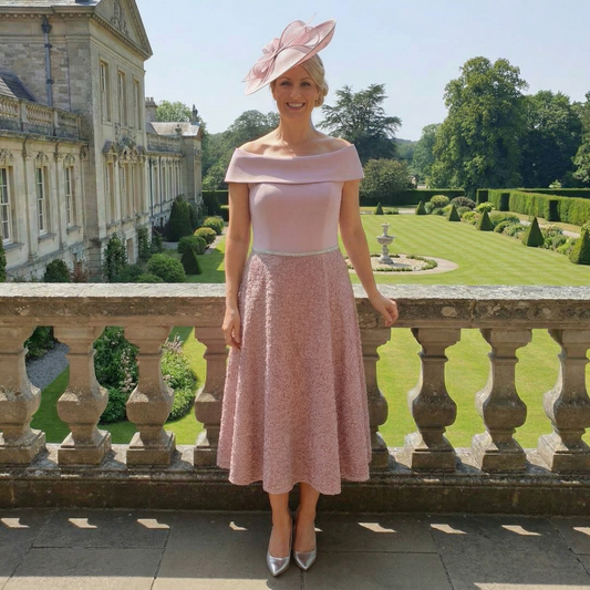 Soft pink Veromia Occasions VO6534 Mother of the Bride Bardot dress with petal‑textured skirt and sequins.