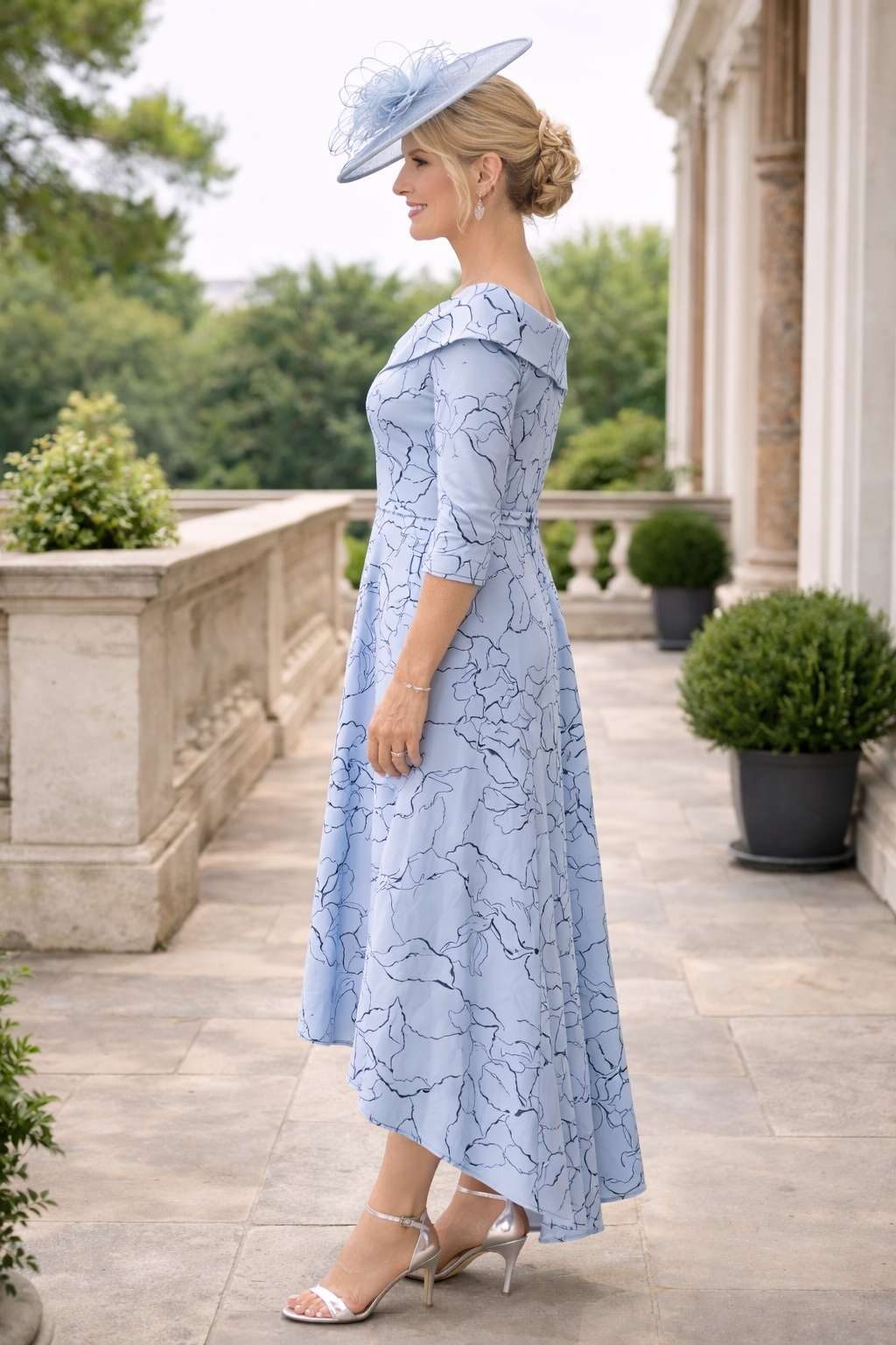 Side angle of the Veromia VO9681 blue high low hem mother of the bride dress showing stretch fabric and embellishments.